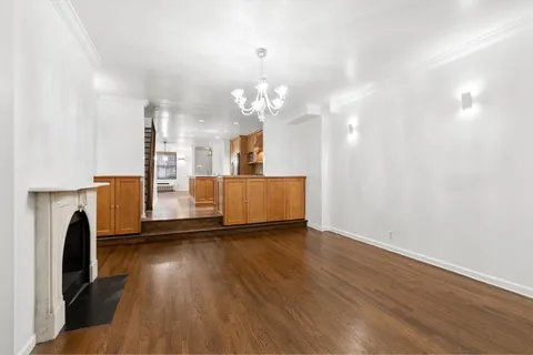 a view of a room with wooden floor and a fireplace