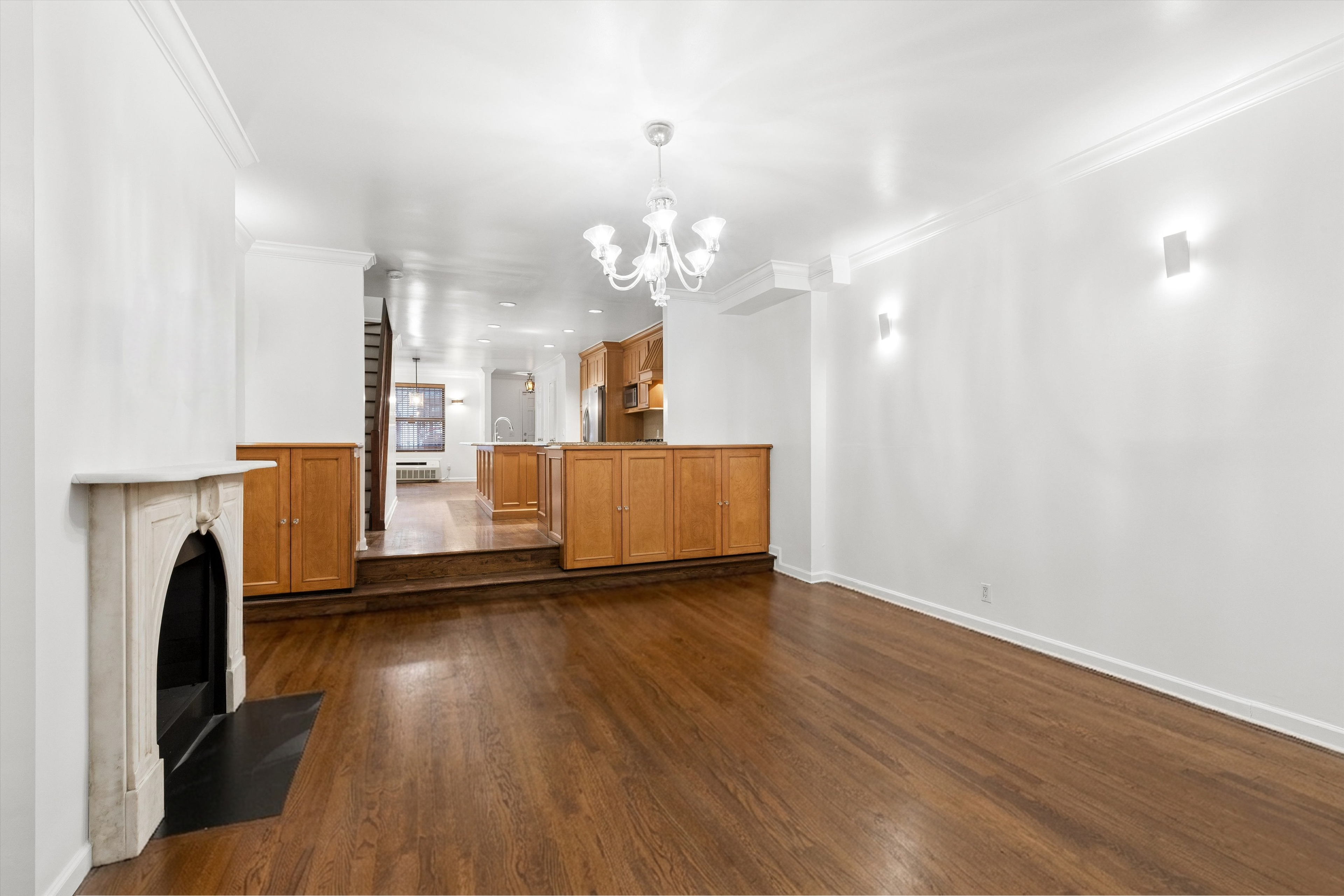 165 West 126th Street Manhattan, NY 10027 - Photo 9 of 40 a view of a room with wooden floor and a fireplace
