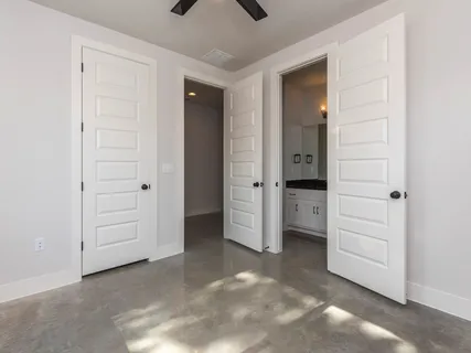 an empty room with closet and mirrors