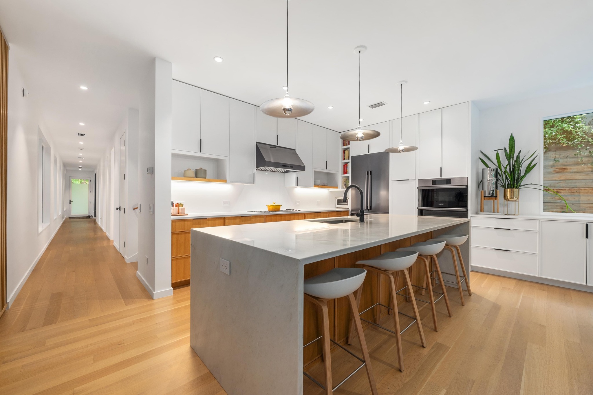 1206 Bickler Road Austin, TX 78704 - Photo 29 of 65 a kitchen with kitchen island granite countertop a sink a center island and stainless steel appliances
