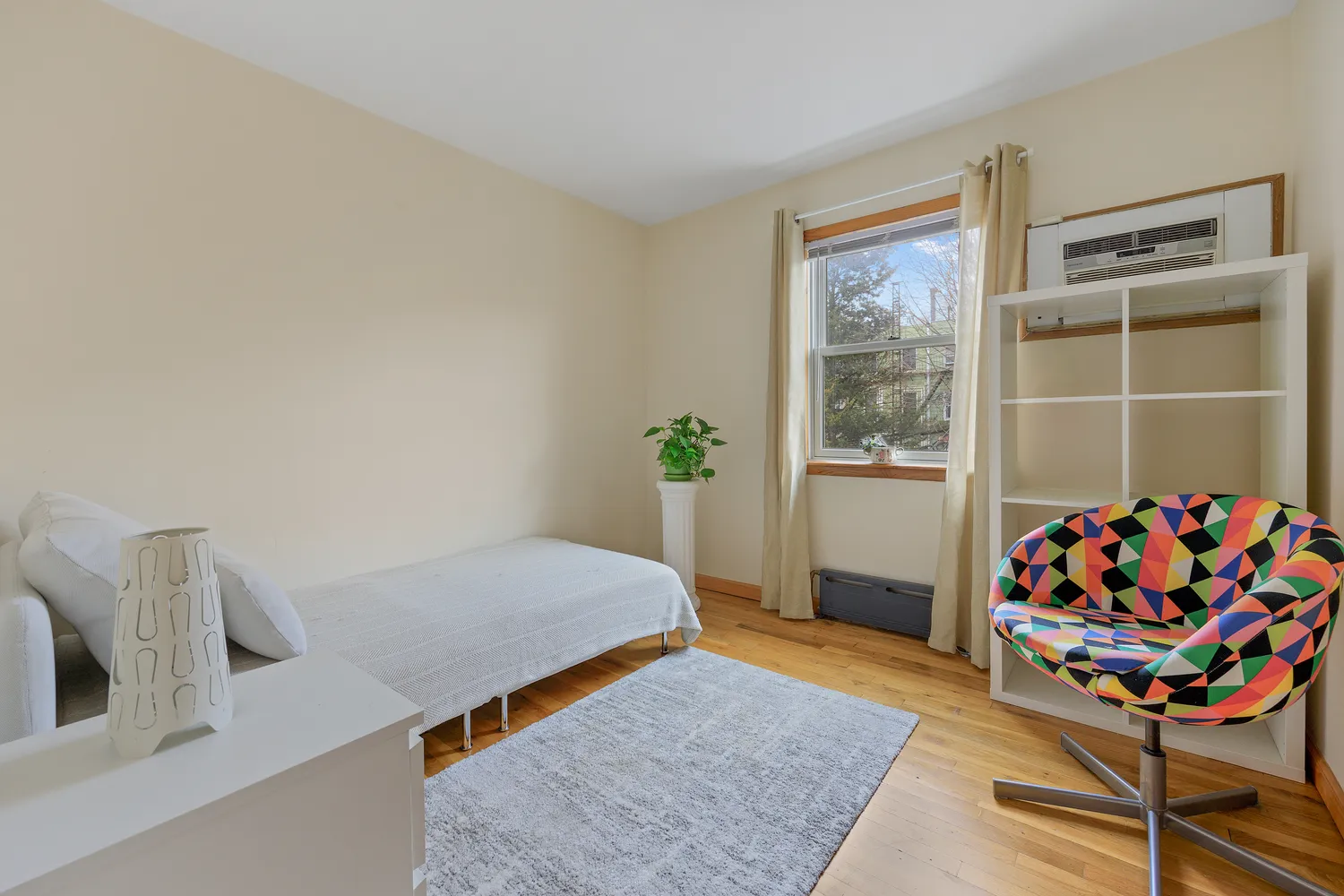 a bedroom with furniture and a window