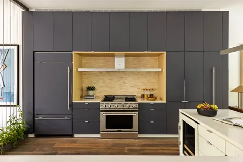 a kitchen with wooden cabinets and a stove top oven
