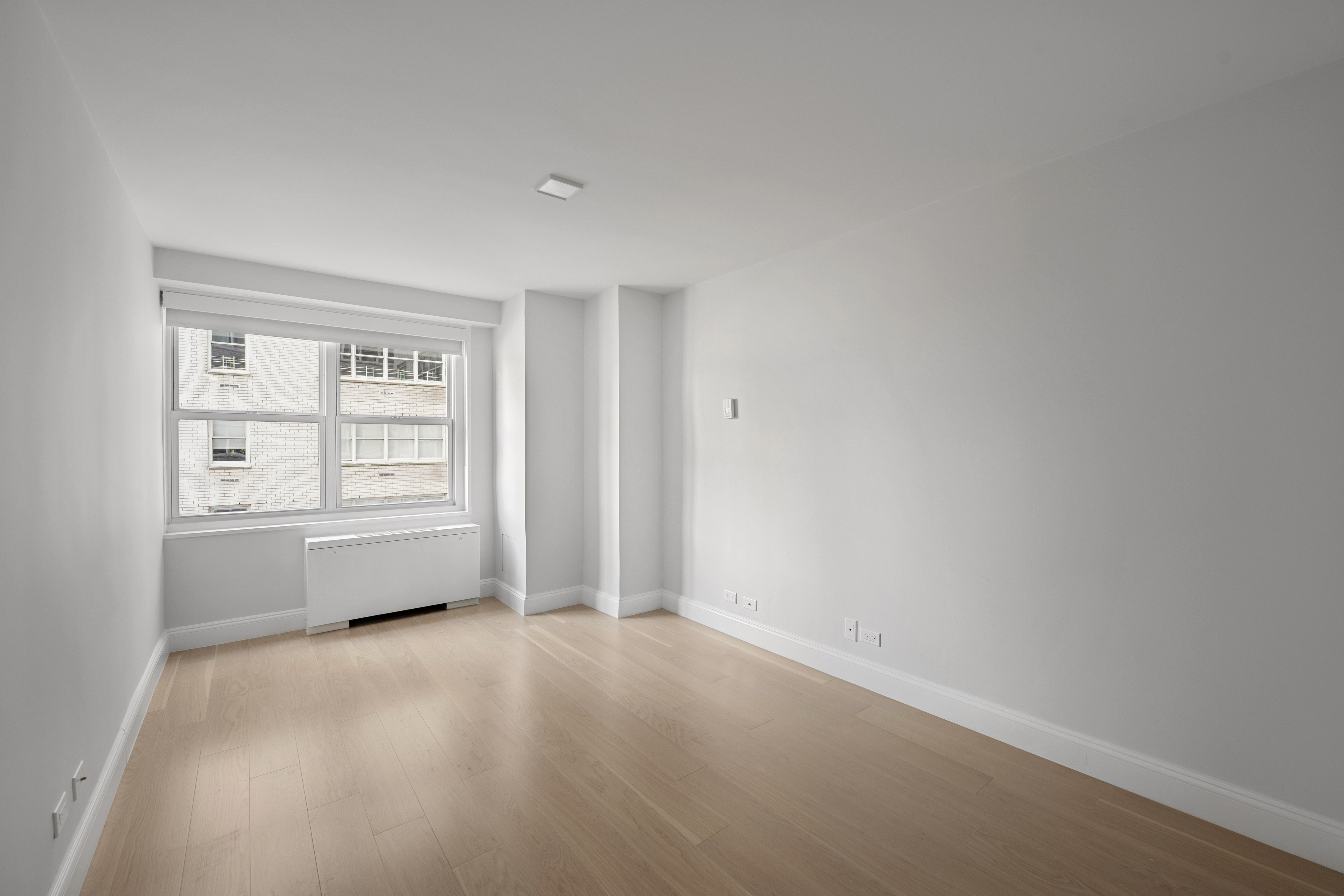 155 West 68th Street, Unit 815 Manhattan, NY 10023 - Photo 9 of 14 an empty room with windows