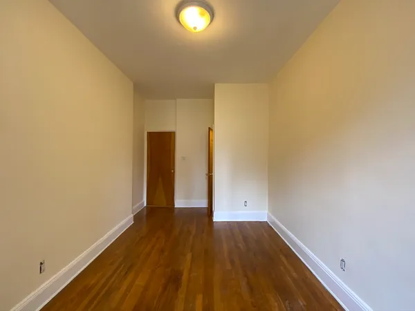 a view of a room with wooden floor