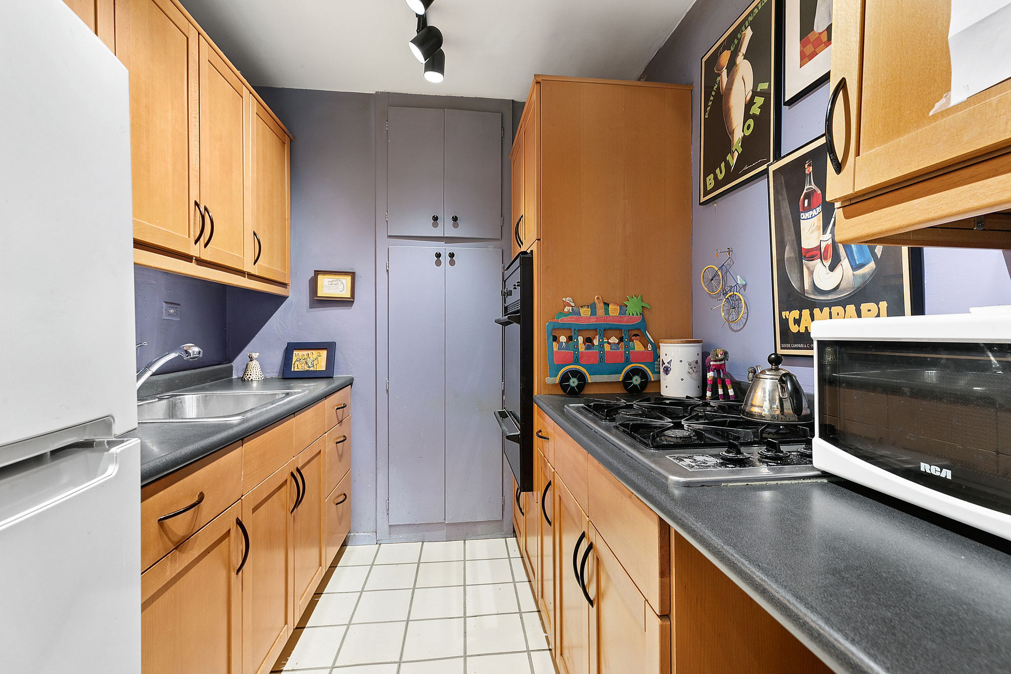 1199 Park Avenue, Unit 2J Manhattan, NY 10128 - Photo 3 of 8 a kitchen with stainless steel appliances granite countertop a stove a sink and a refrigerator