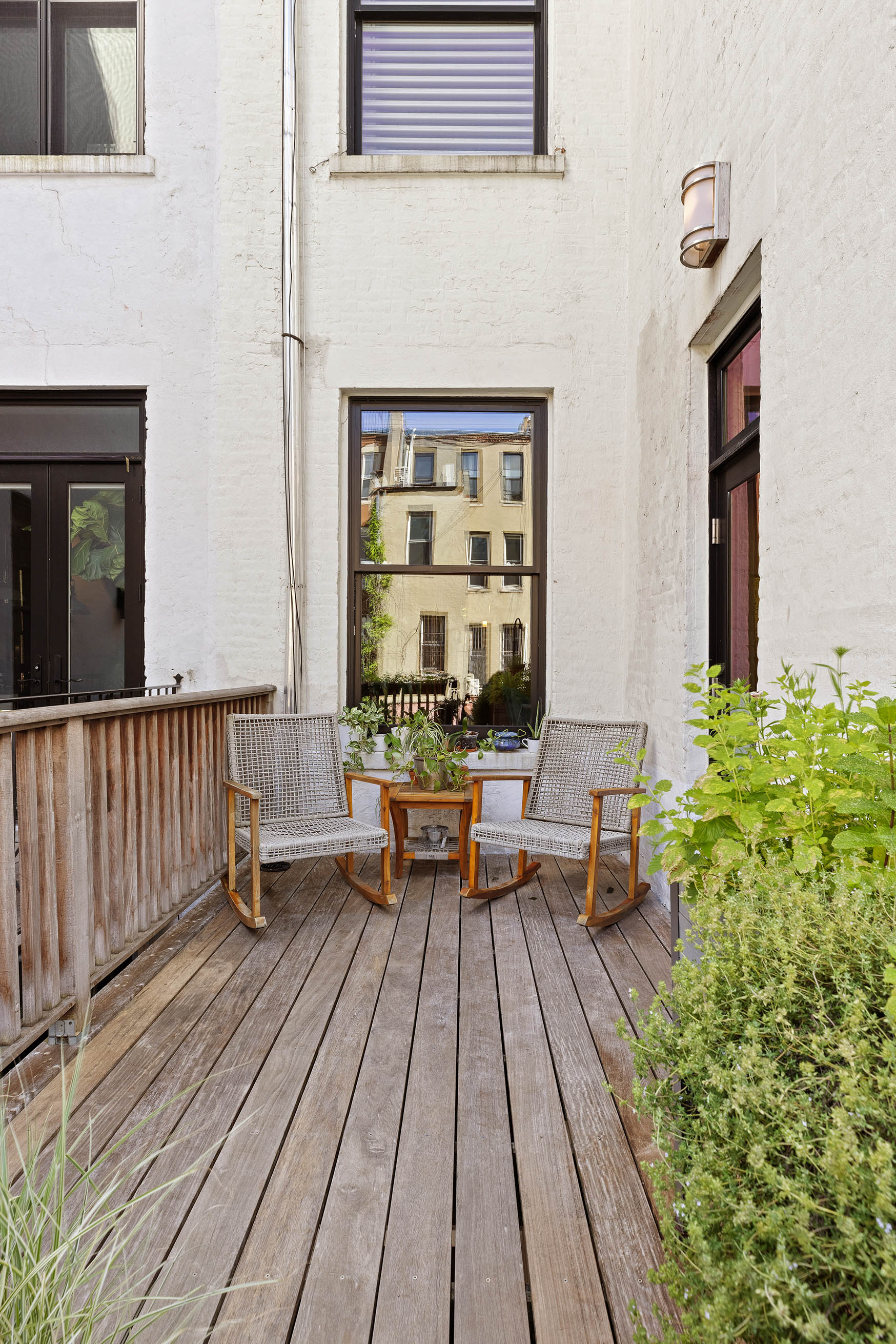 89 West 119th Street Manhattan, NY 10026 - Photo 20 of 22 a balcony with wooden floor table and chairs