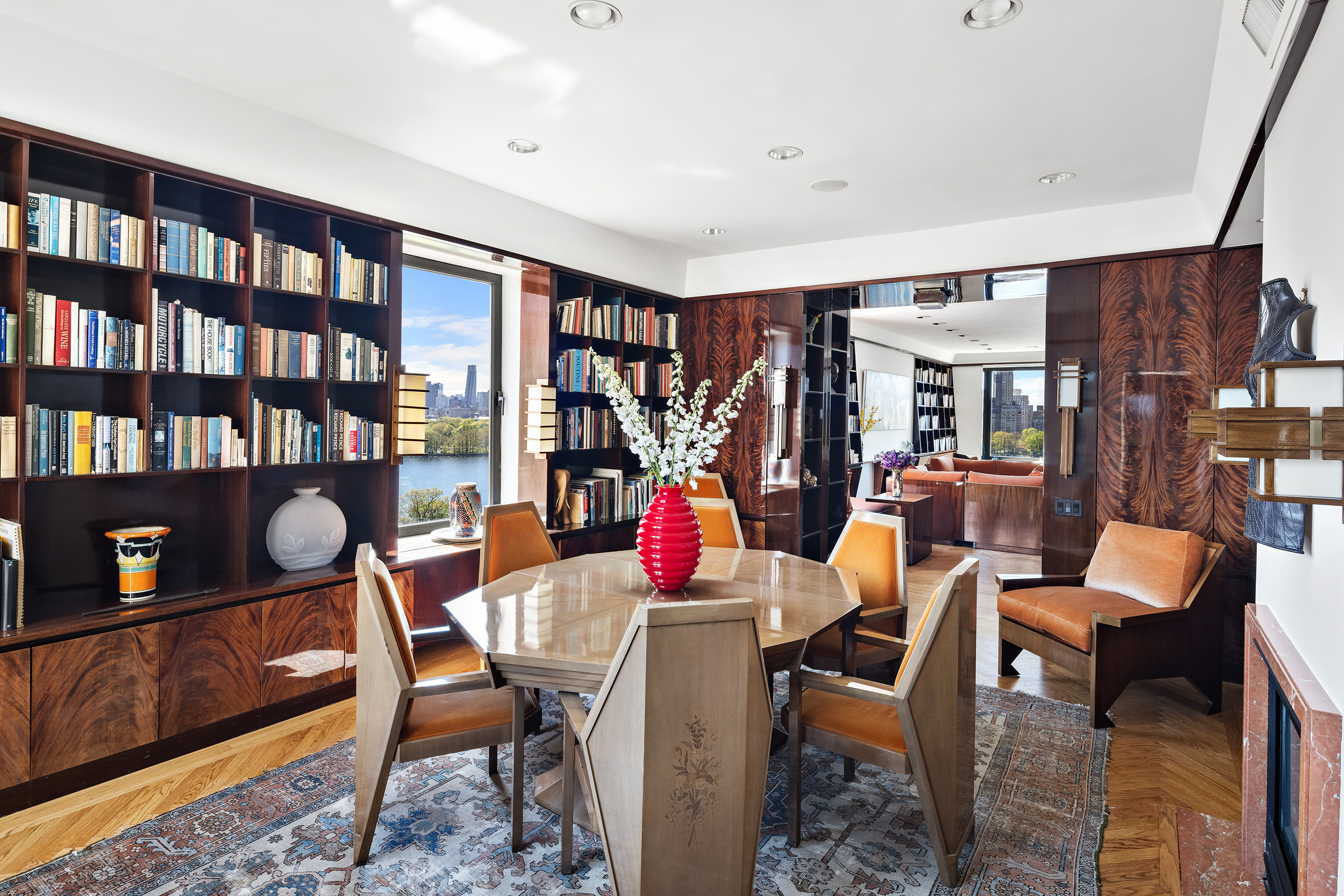 1115 5th Avenue, Unit 15A Manhattan, NY 10128 - Photo 11 of 27 a dining room with furniture and a book shelf