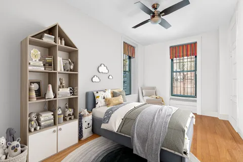 a bedroom with a bed and wooden floor
