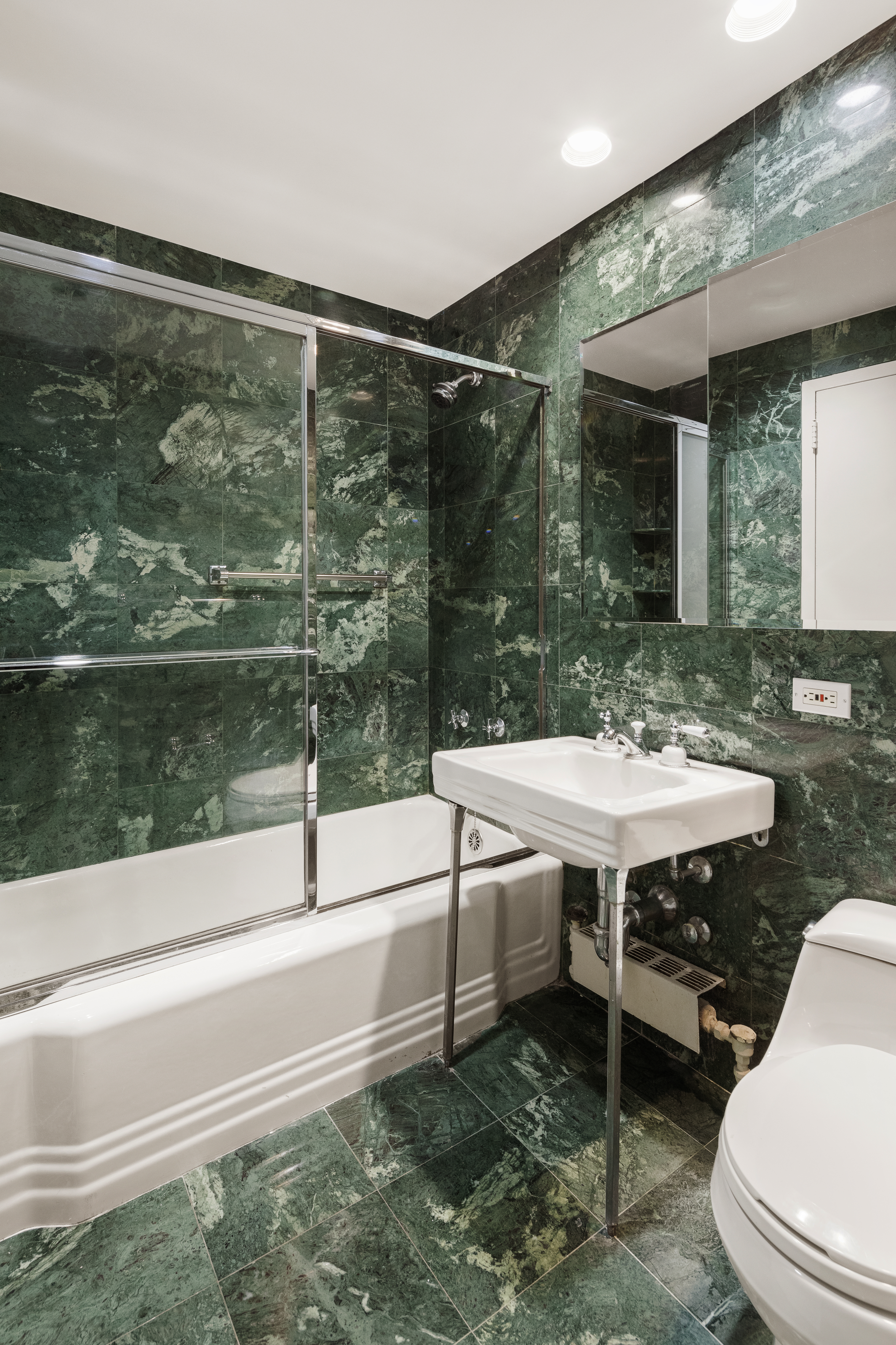 11 5th Avenue, Unit 5LW Manhattan, NY 10003 - Photo 11 of 19 a bathroom with a sink and a large mirror