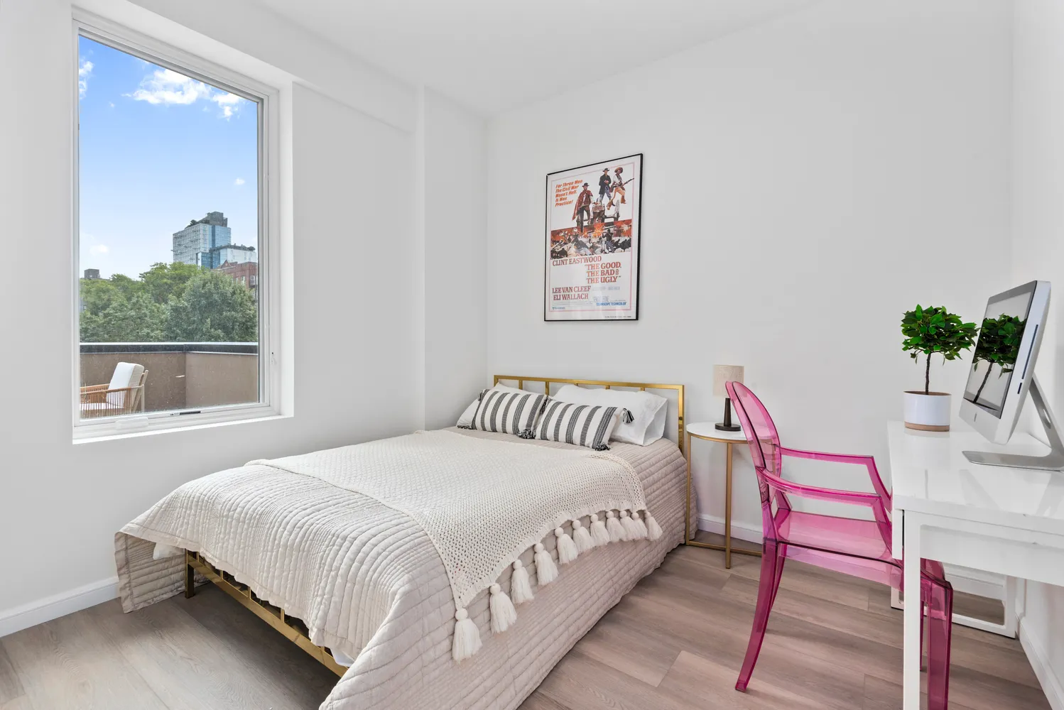 a bedroom with a bed and a potted plant