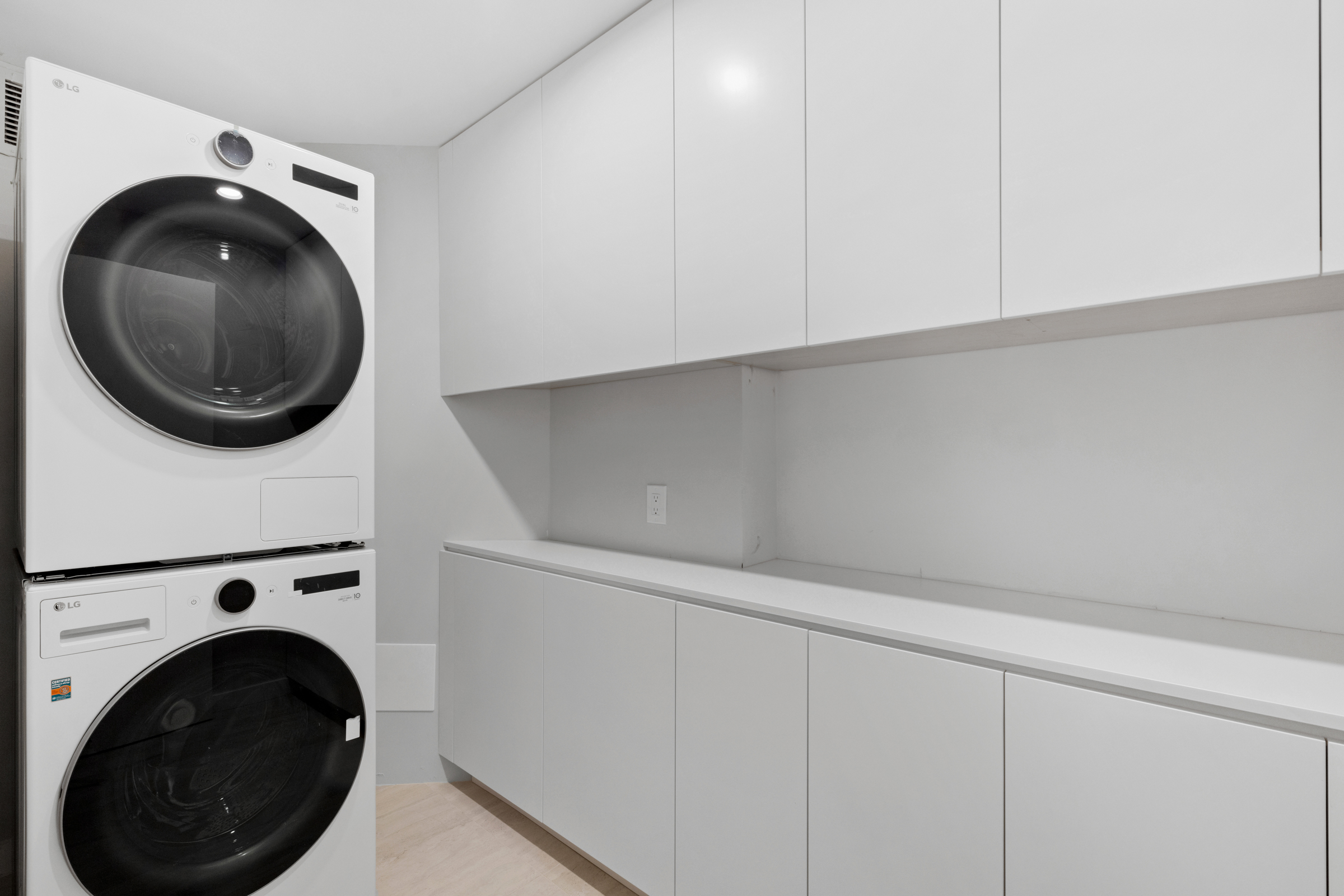 240 East 47th Street, Unit 16CD Manhattan, NY 10017 - Photo 8 of 14 a utility room with dryer and washer