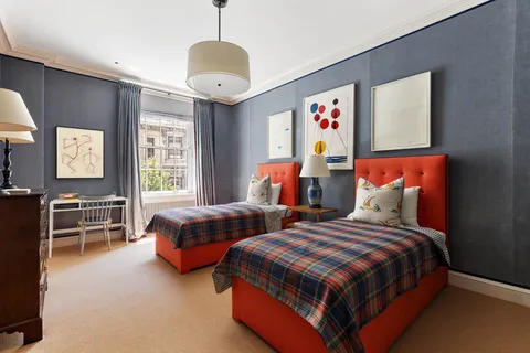 a bedroom with two beds and painted walls