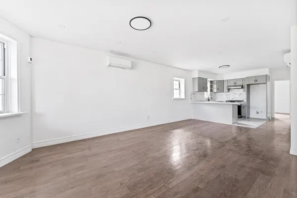 a view of a kitchen with a sink and a refrigerator