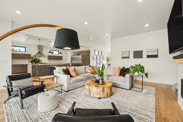 a living room with furniture and wooden floor