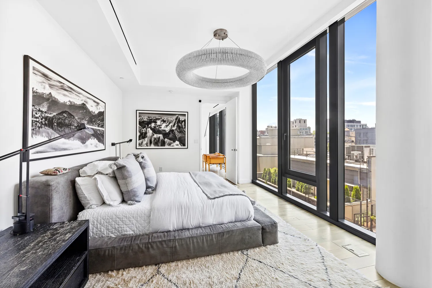 a bedroom with a large bed and a large window