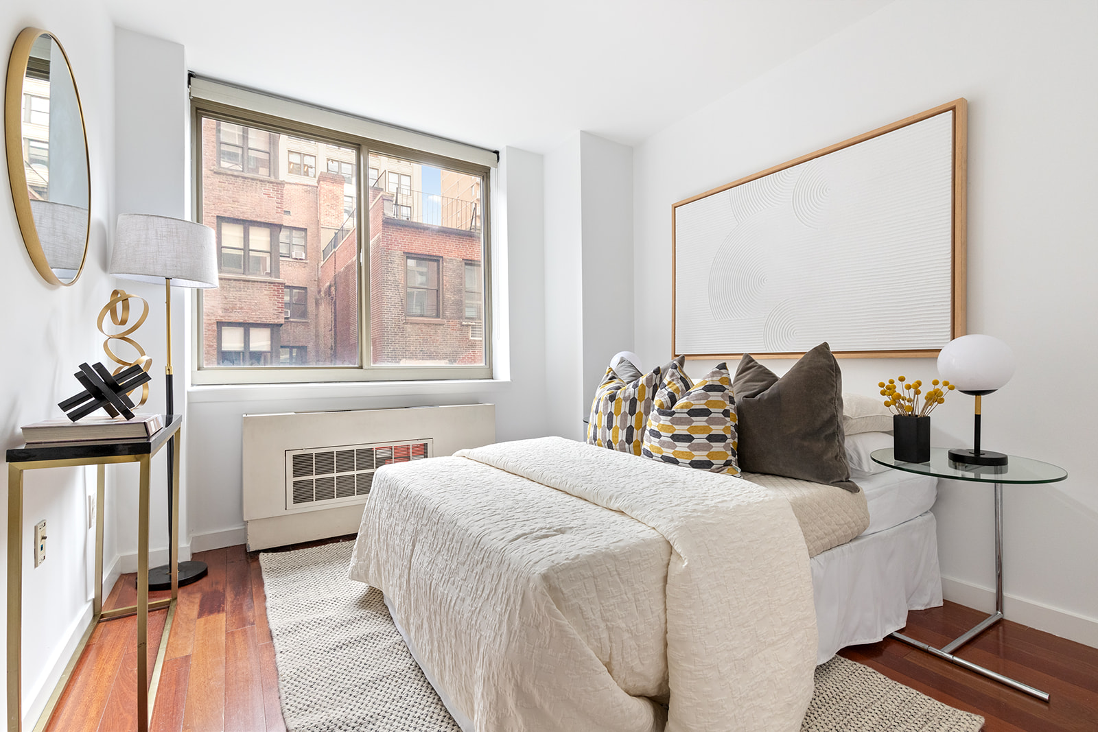 121 East 23rd Street, Unit 4H Manhattan, NY 10010 - Photo 4 of 12 a bedroom with a bed and a flat tv screen on dresser