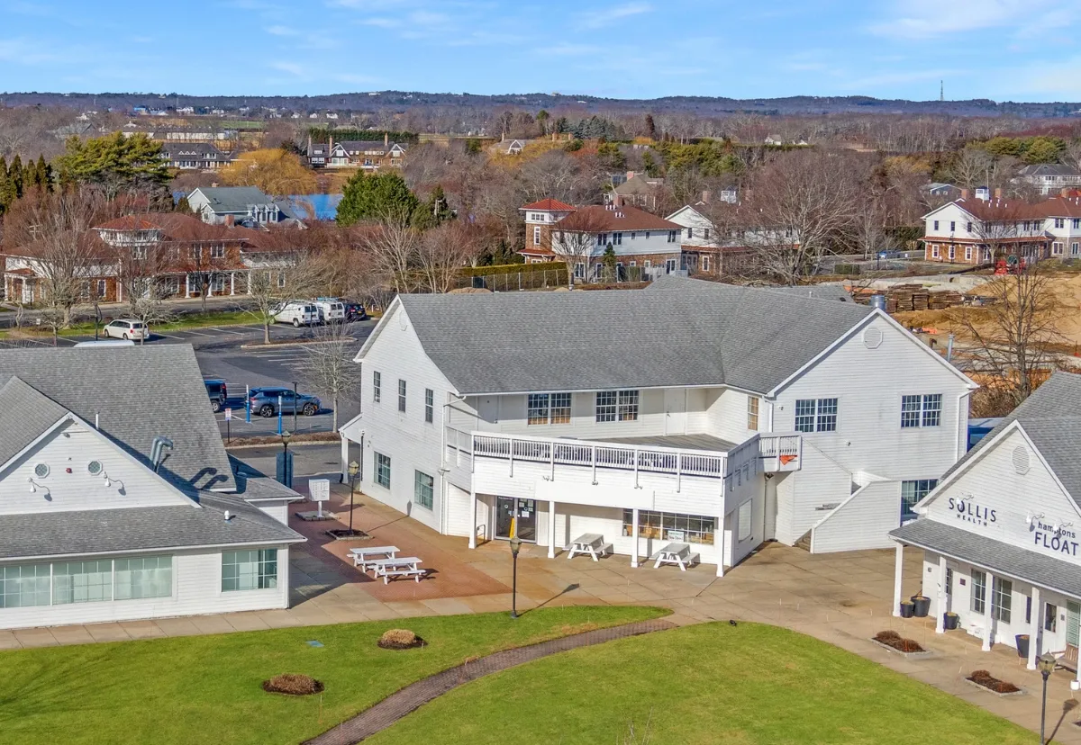 an aerial view of residential houses with outdoor space and river