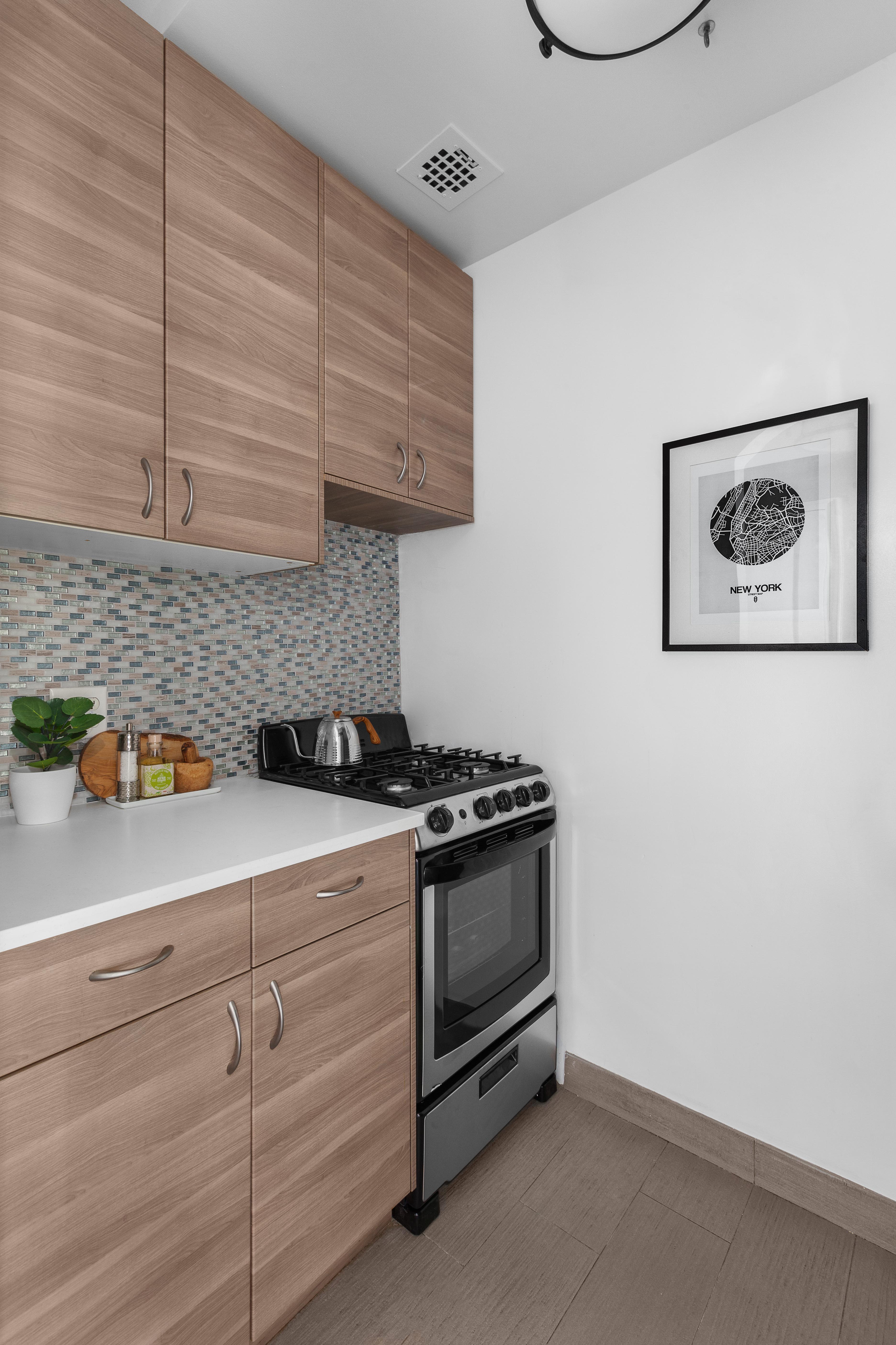 470 West 24th Street, Unit 16H Manhattan, NY 10011 - Photo 7 of 13 a kitchen with appliances and cabinets