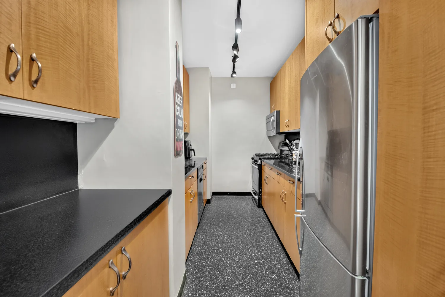 a kitchen with a refrigerator and a sink