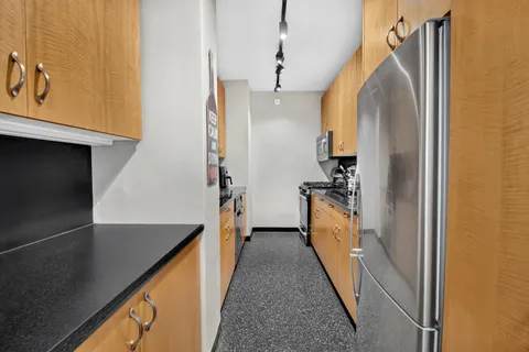 a kitchen with a refrigerator and a sink