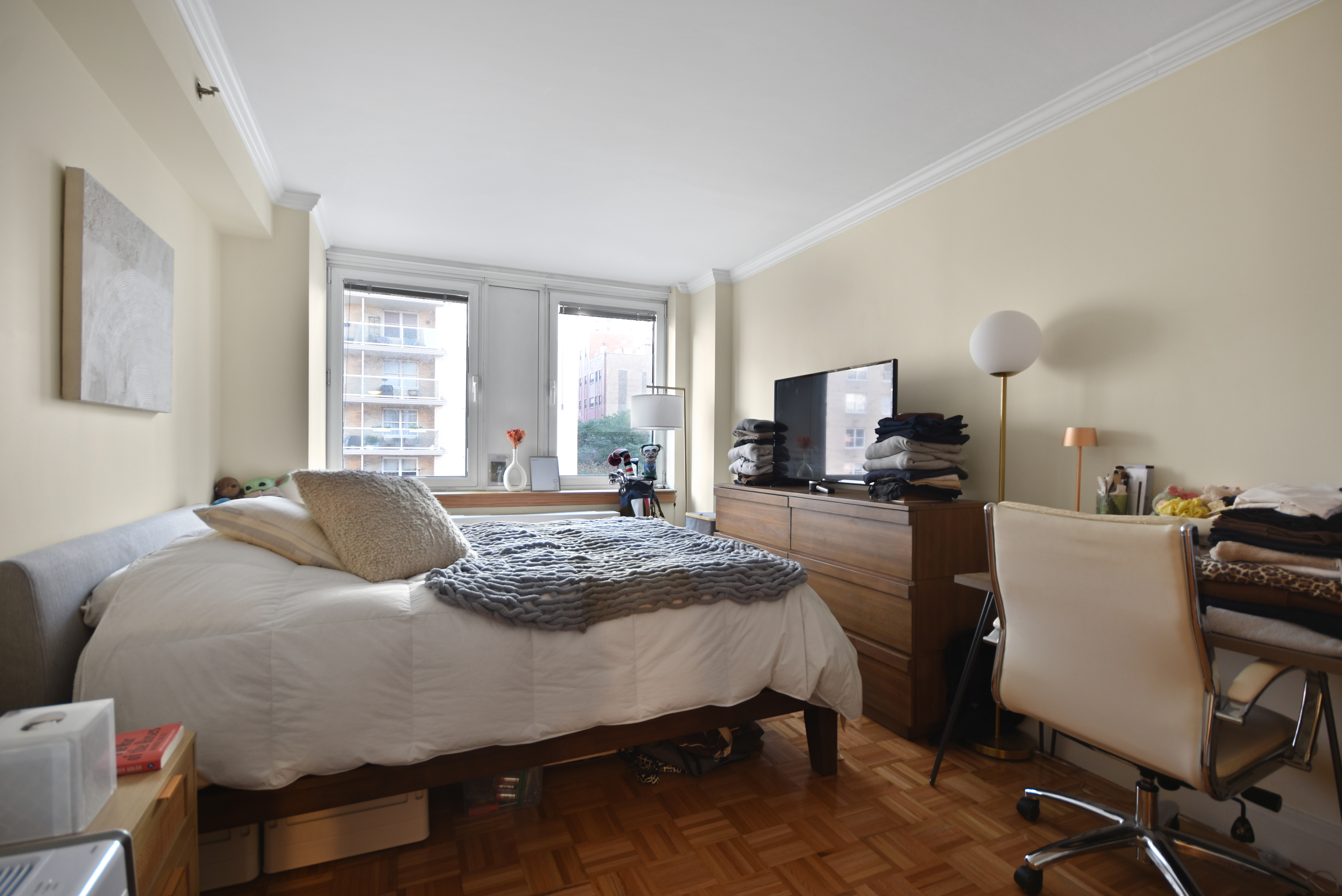404 East 76th Street, Unit 4A Manhattan, NY 10021 - Photo 3 of 6 a bedroom with a bed and large windows