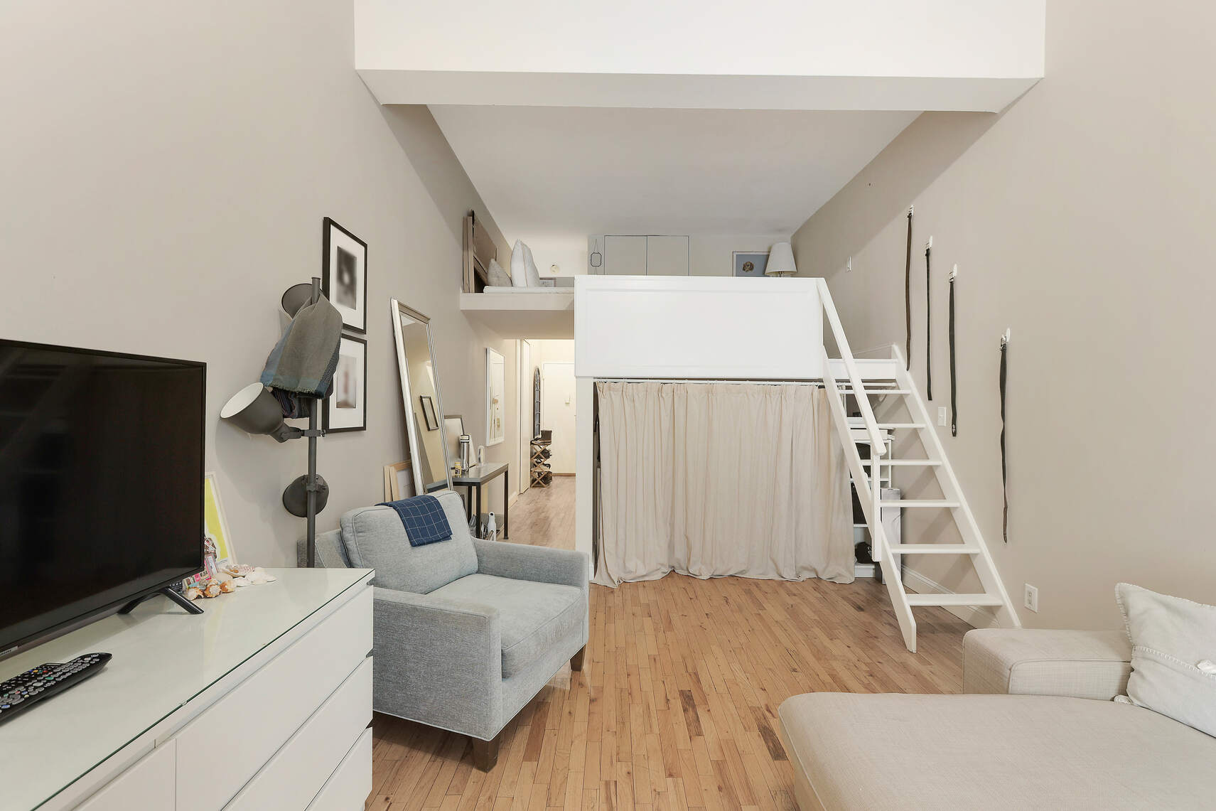 310 East 23rd Street, Unit 7C Manhattan, NY 10010 - Photo 5 of 18 a living room with furniture and a flat screen tv