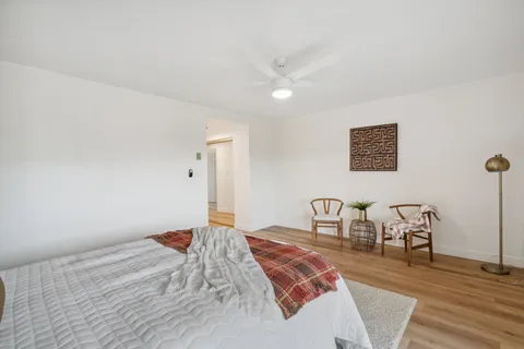 a view of a hallway with wooden floor