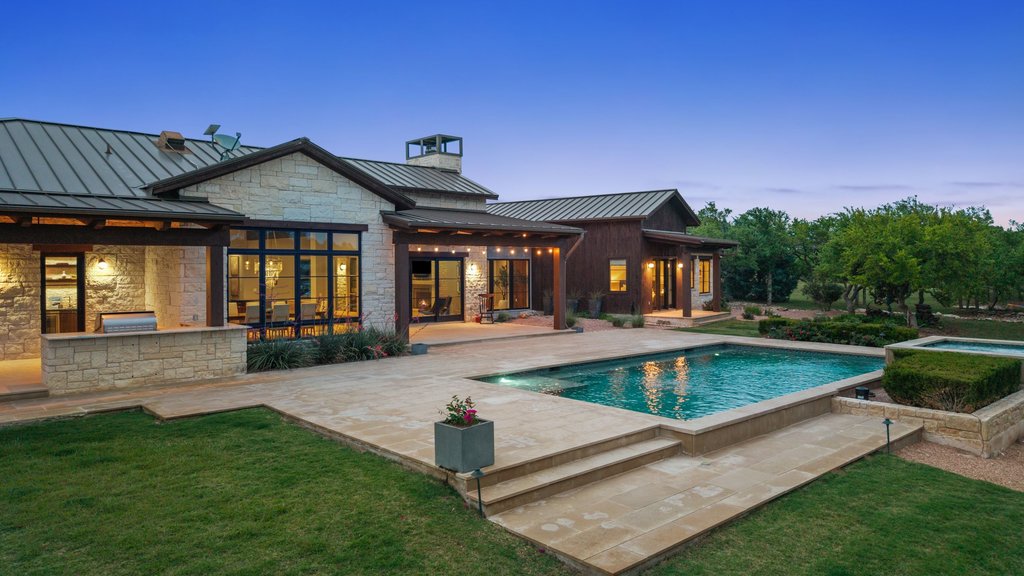 2560 Bell Springs Road Dripping Springs, TX 78620 - Photo 27 of 42 a view of a house with pool and chairs