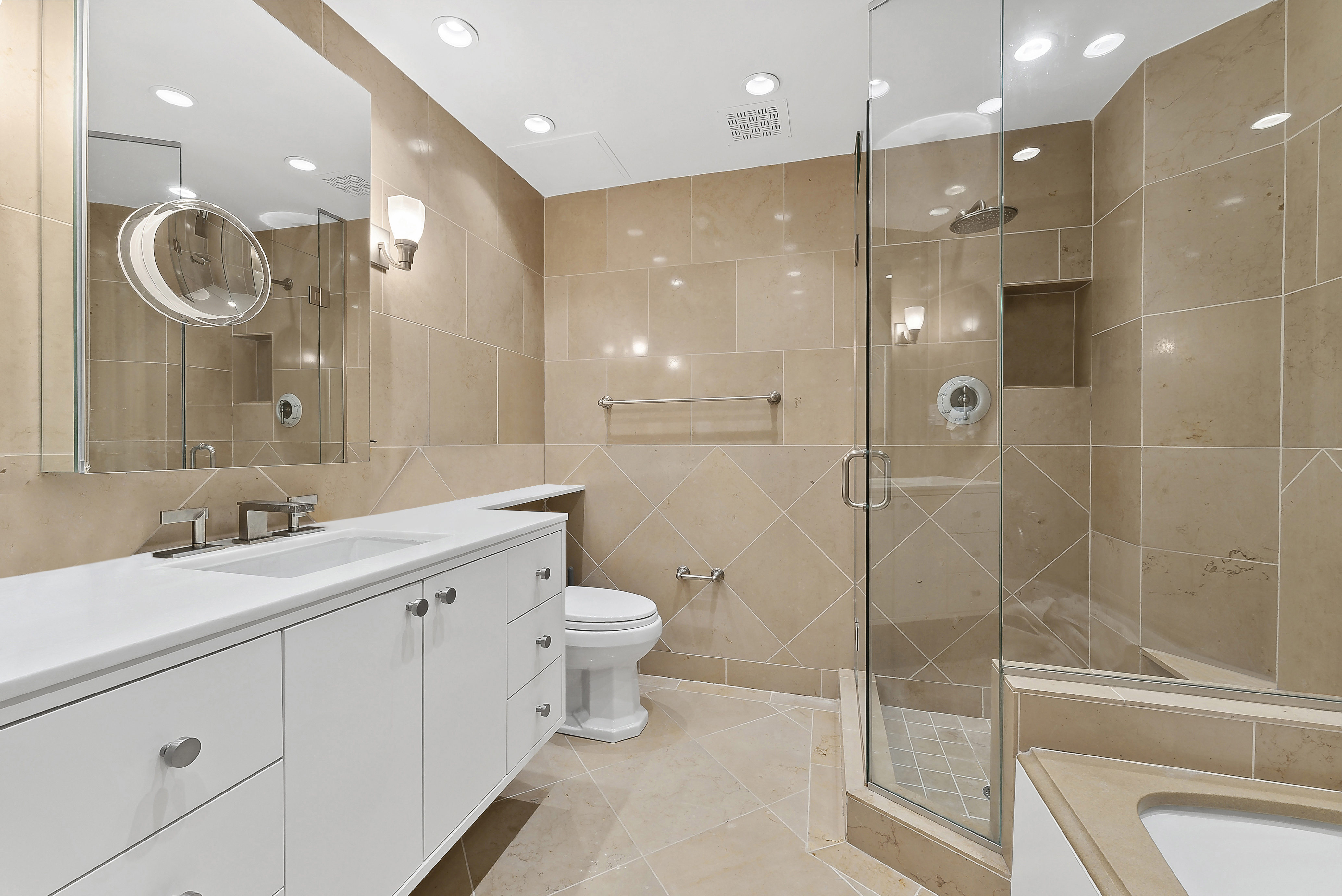 3 East 75th Street, Unit 1C Manhattan, NY 10021 - Photo 4 of 7 a bathroom with a sink a toilet and shower