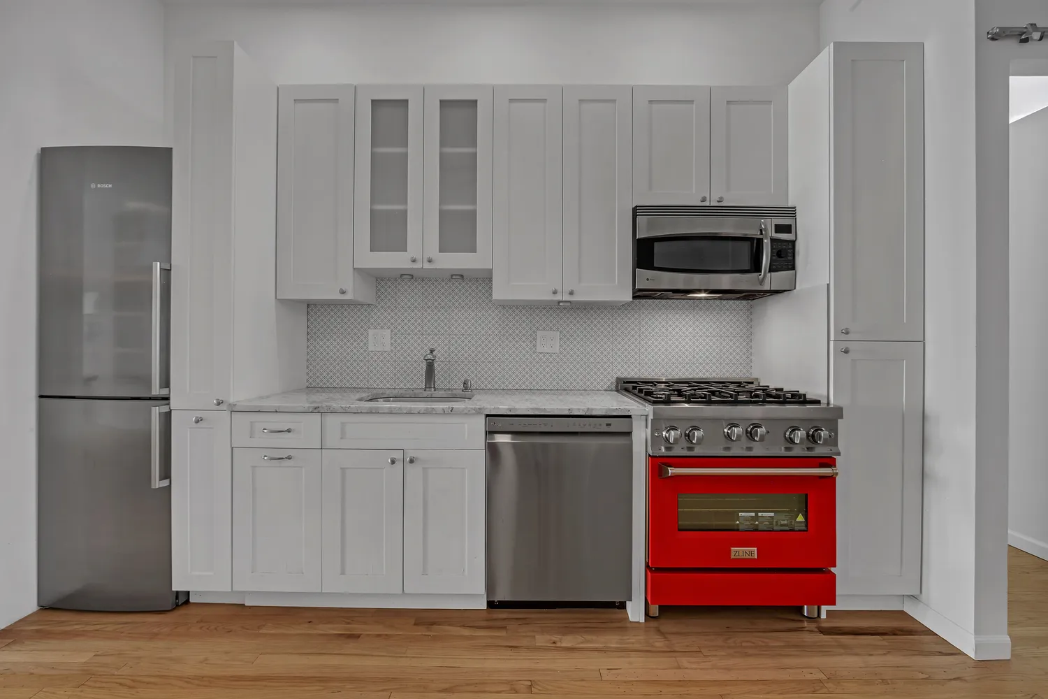 a kitchen with stainless steel appliances granite countertop a stove a microwave and cabinets