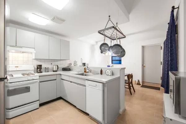 a kitchen with a sink cabinets and window