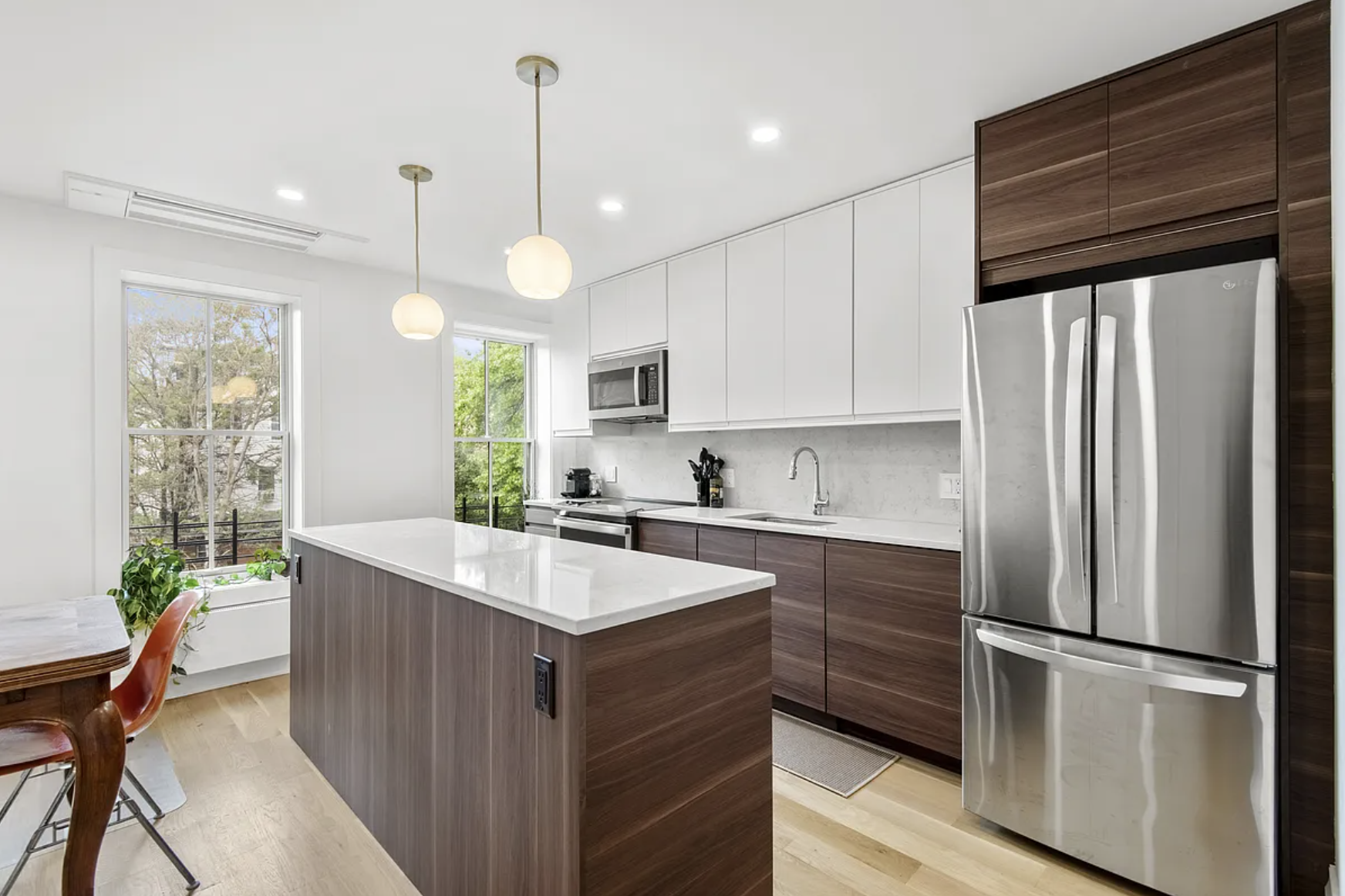 169 Putnam Avenue, Unit 2 Brooklyn, NY 11216 - Photo 3 of 10 a kitchen with kitchen island a counter appliances a sink and cabinets