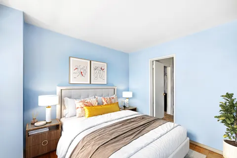 a bedroom with a bed and a painting on the wall