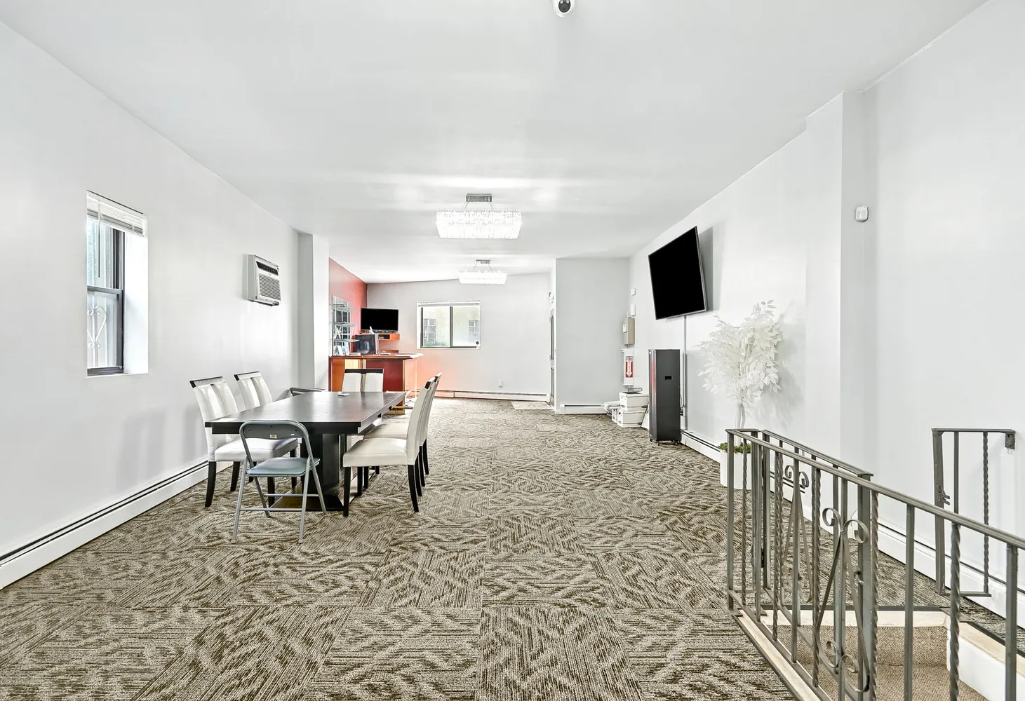 a view of a livingroom with furniture and a flat screen tv