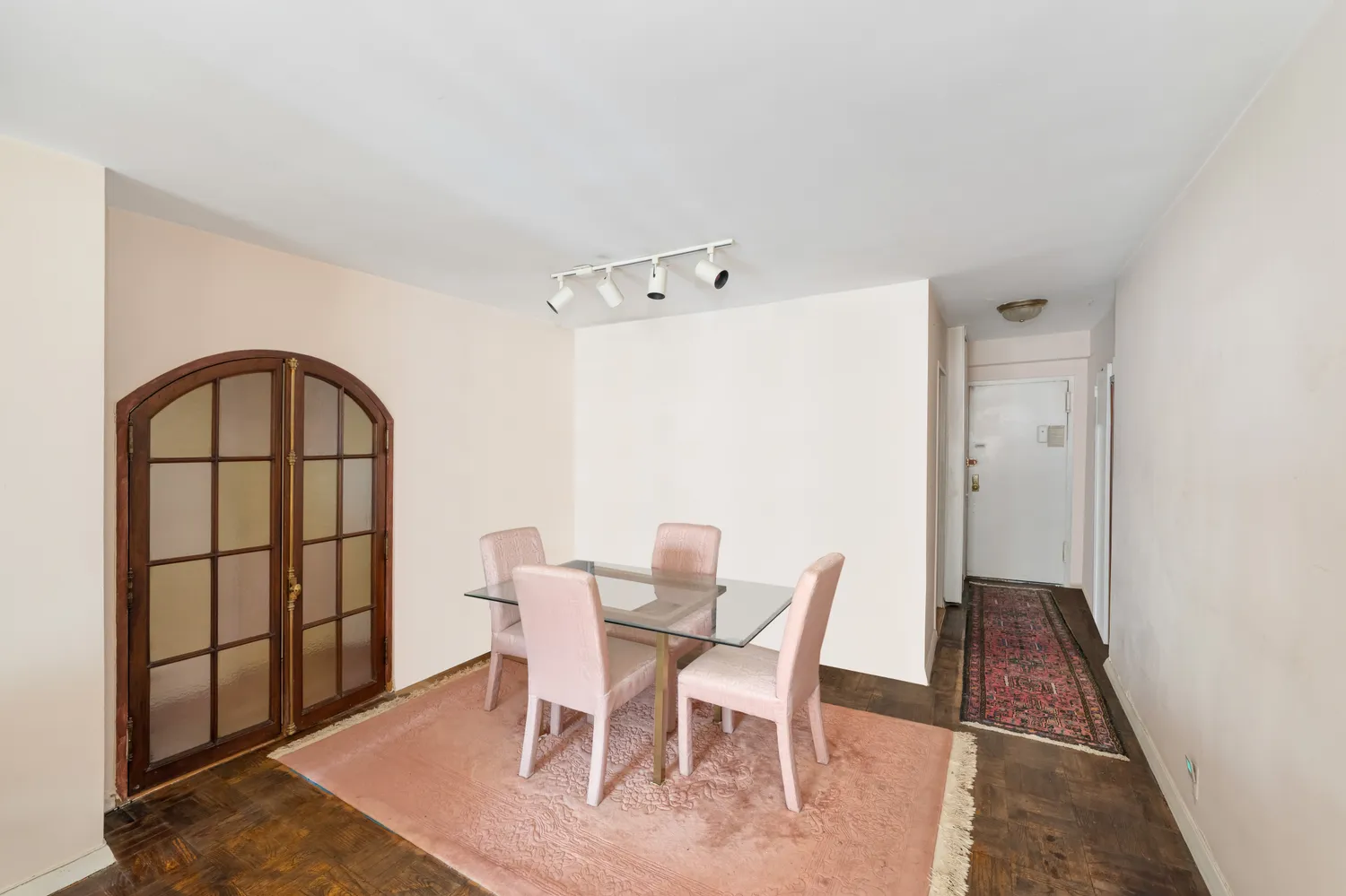 a view of a dining room with furniture and a window