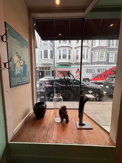 a view of a dining room with furniture a chandelier and a window