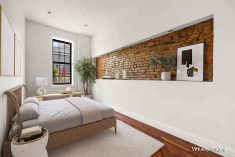 a bedroom with a bed and window