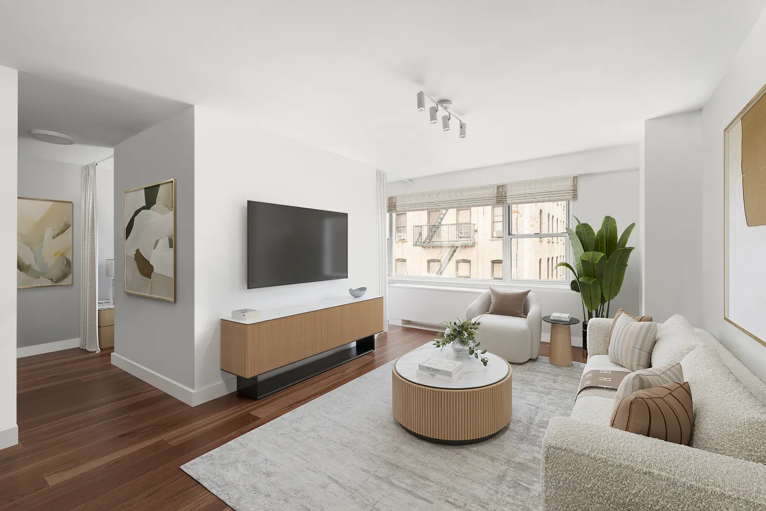 a living room with furniture and a potted plant