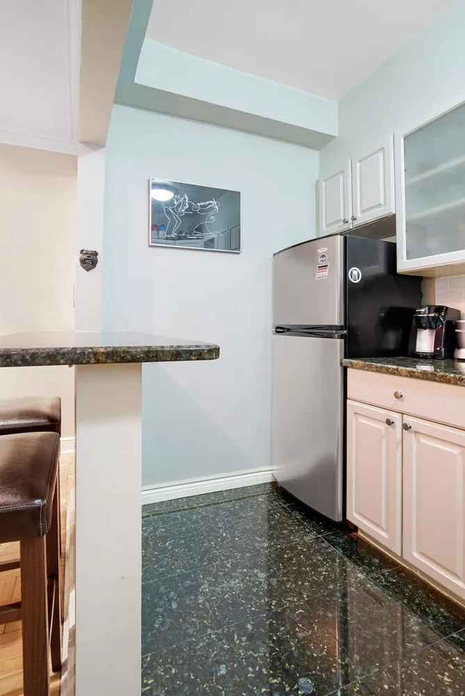 a kitchen with a refrigerator a stove a microwave and cabinets