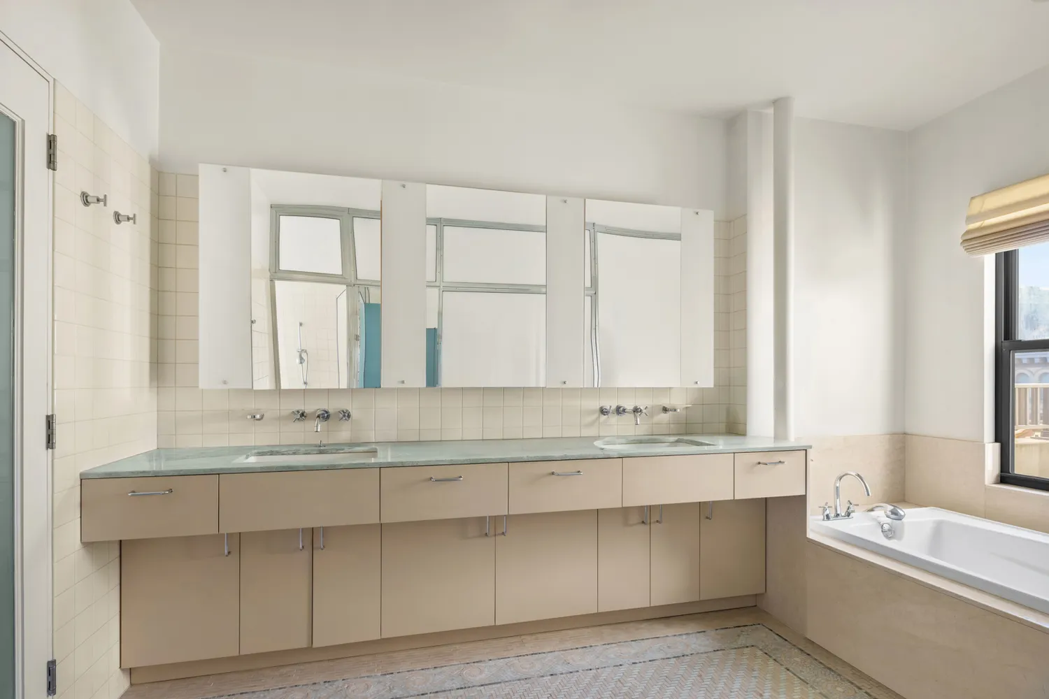 a bathroom with a bathtub a sink and a window