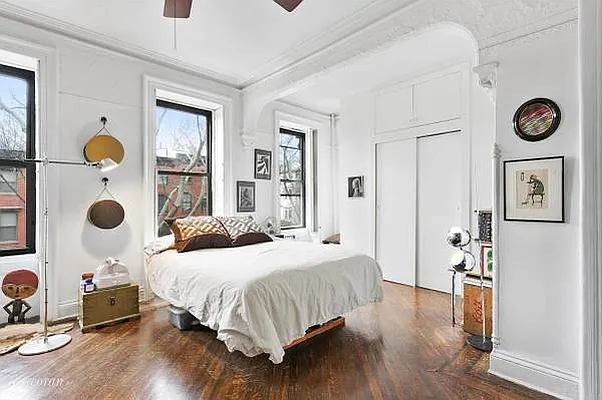 393 Clermont Avenue, Unit 3 Brooklyn, NY 11238 - Photo 2 of 10 a bedroom with a bed and painting on the wall