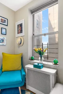 a living room with furniture and flowers