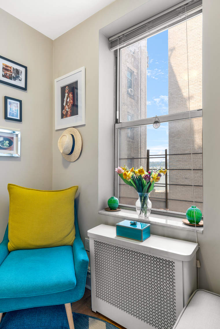 156-08 Riverside Drive West, Unit 2C Manhattan, NY 10032 - Photo 9 of 10 a living room with furniture and flowers