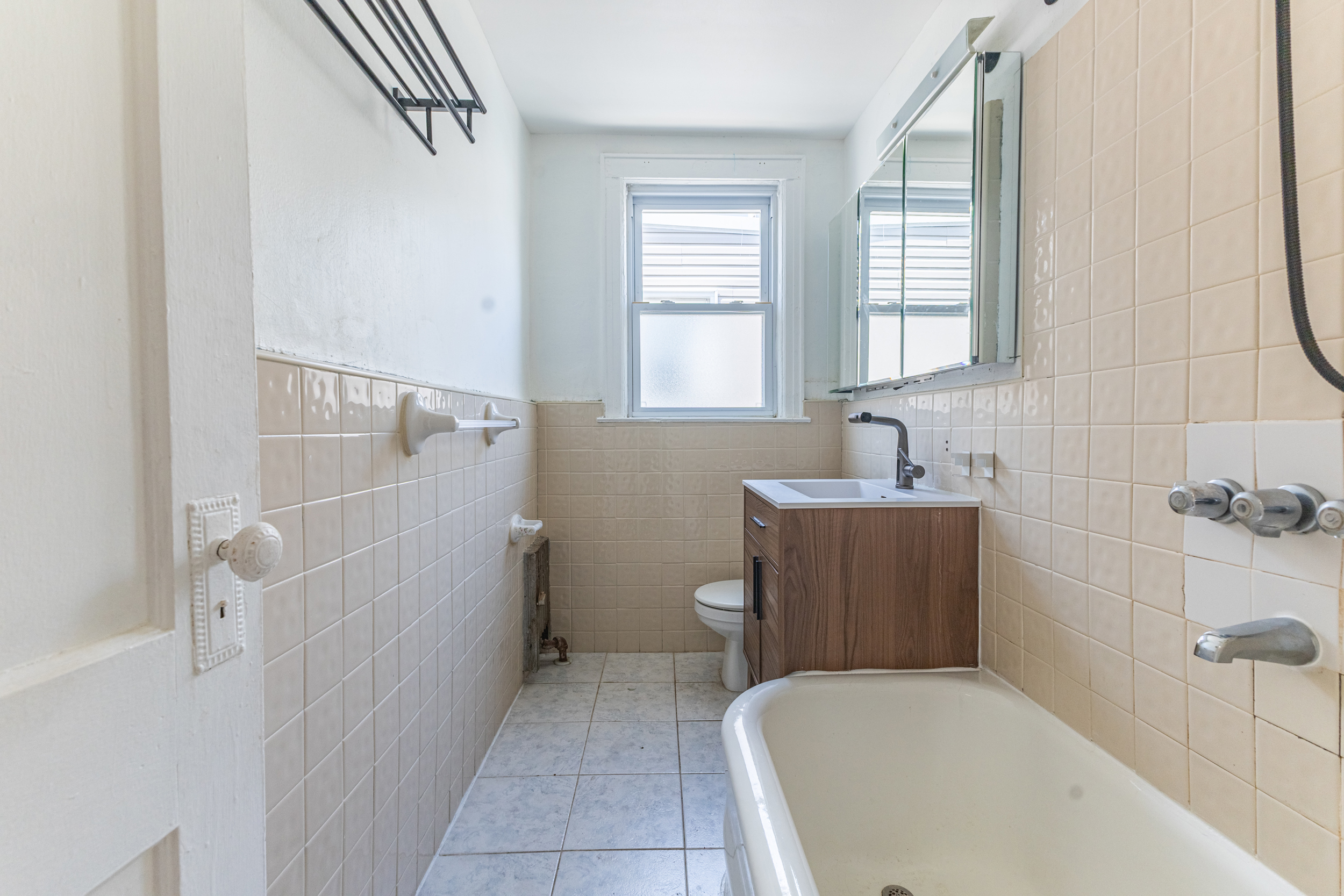 69-29 67th Place Queens, NY 11385 - Photo 19 of 24 a bathroom with a bathtub and sink