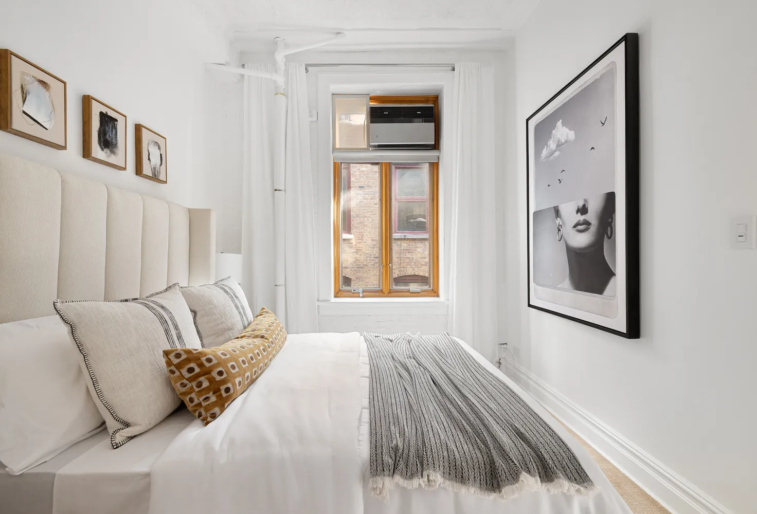 a bedroom with a bed and a painting on the wall