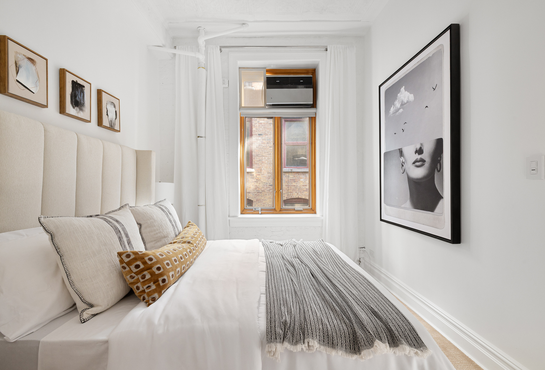 107 West 25th Street, Unit 5B Manhattan, NY 10001 - Photo 7 of 16 a bedroom with a bed and a painting on the wall