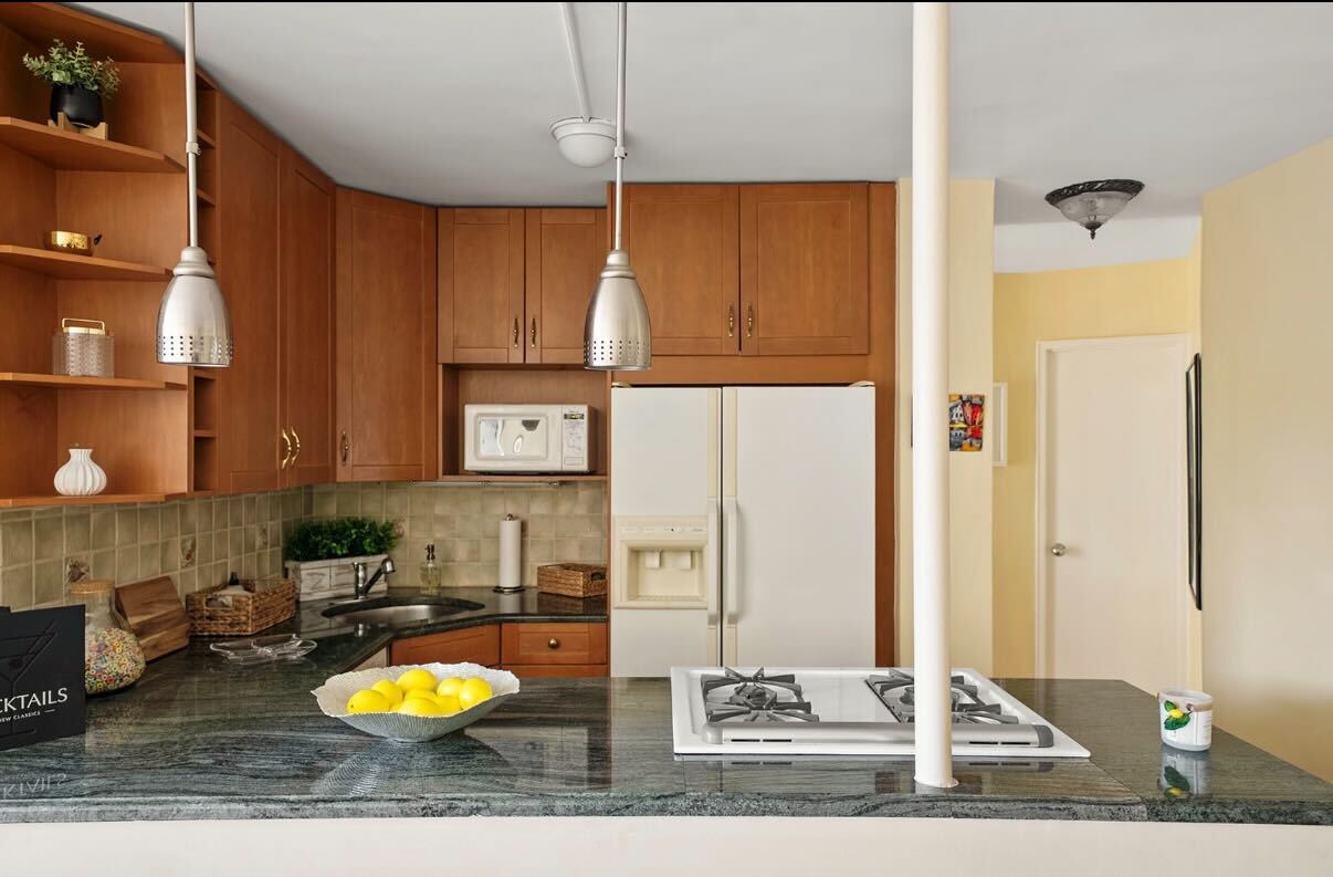 225 East 36th Street, Unit 10N Manhattan, NY 10016 - Photo 4 of 13 a view of a living room and bathroom