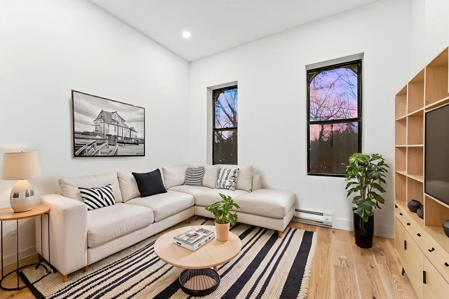 a living room with furniture and wooden floor