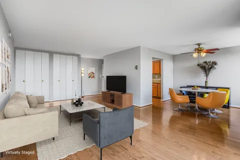 a living room with furniture and wooden floor