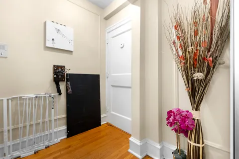 a bedroom with a bed and a painting on the wall